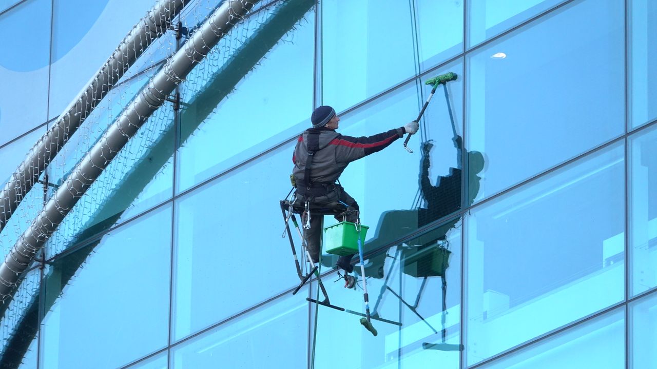 heros-img A window cleaner is working on a tall glass building, delivering spotless results.